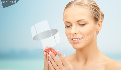 Image of beautiful woman with seashell over blue background