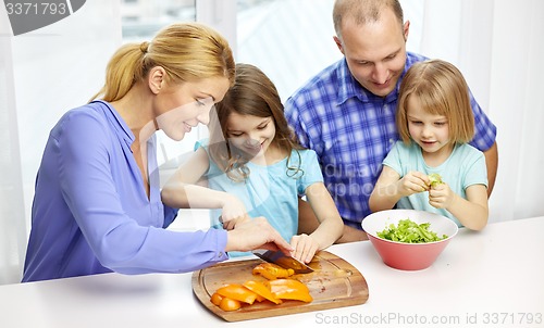 Image of happy family with two kids cooking at home