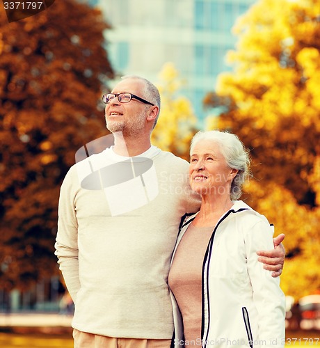 Image of senior couple hugging in city park