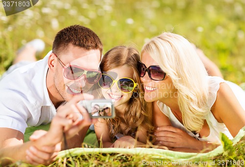 Image of happy family with camera taking picture