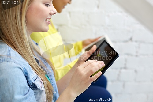 Image of close up of women with tablet pc on stairs