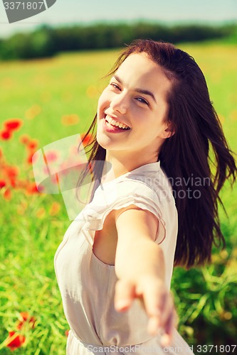 Image of laughing young woman on poppy field