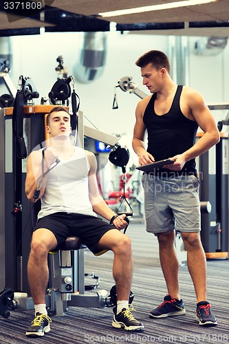 Image of man exercising on gym machine