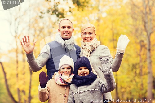 Image of happy family in autumn park