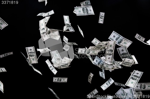 Image of close up of us dollar money flying over black