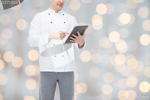 Image of close up of happy male chef cook holding tablet pc