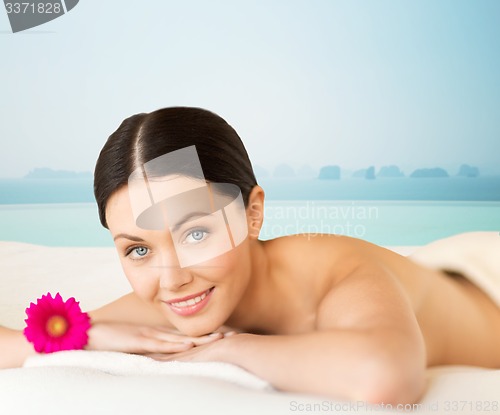 Image of happy beautiful woman lying in spa