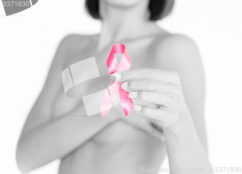 Image of hand holding pink breast cancer awareness ribbon