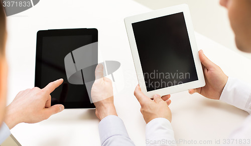 Image of close up of businessman hands with tablet pc