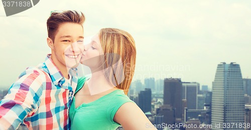 Image of happy couple taking selfie over city background