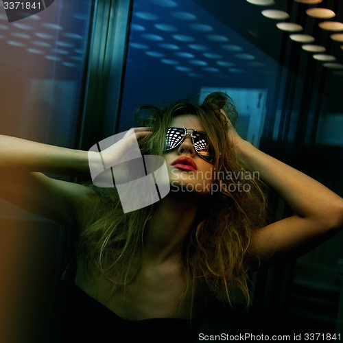 Image of fashionable woman in nightclub