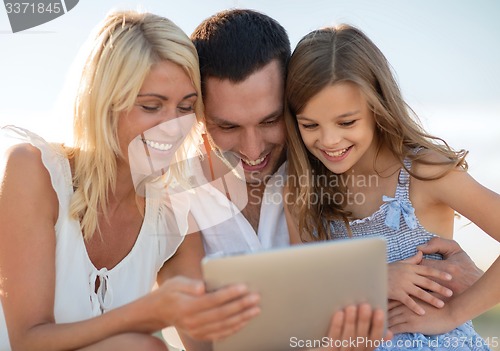 Image of happy family with tablet pc taking picture