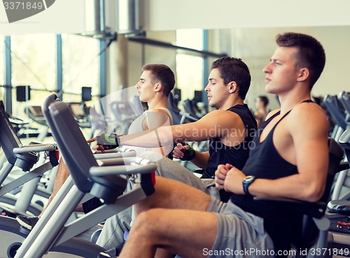 Image of men working out on exercise bike in gym