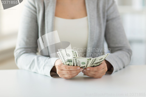 Image of close up of woman hands counting us dollar money