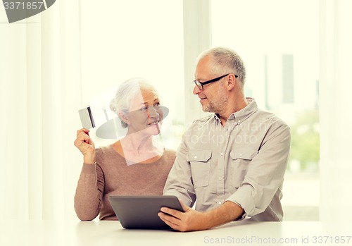 Image of happy senior couple with tablet pc and credit card