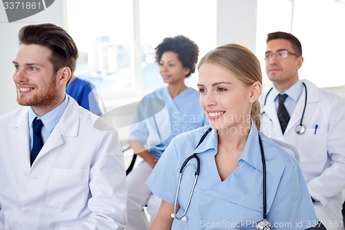 Image of group of happy doctors on seminar at hospital