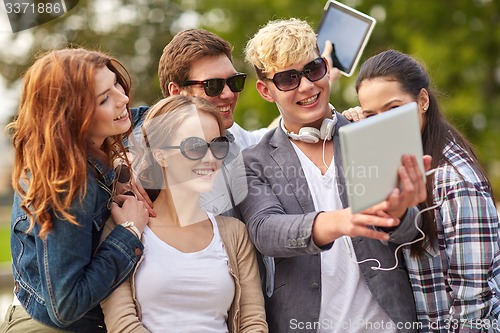 Image of students or teenagers with tablet pc taking selfie