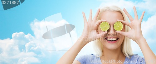 Image of happy woman having fun covering eyes with lime