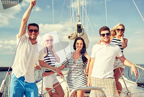 Image of smiling friends sailing on yacht