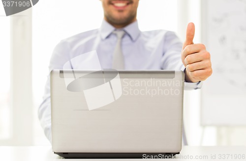 Image of close up of businessman hands with laptop