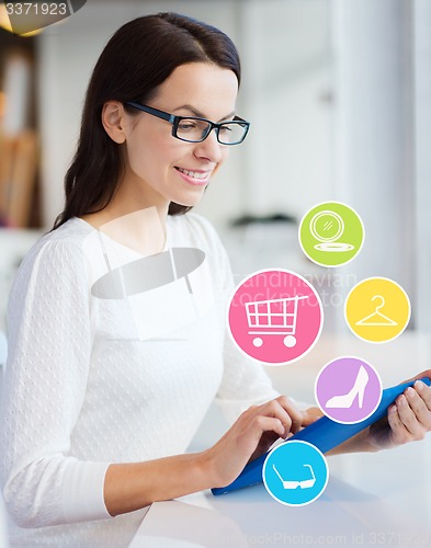 Image of smiling woman with tablet pc shopping online