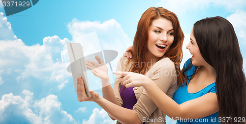 Image of two smiling teenagers with tablet pc computer