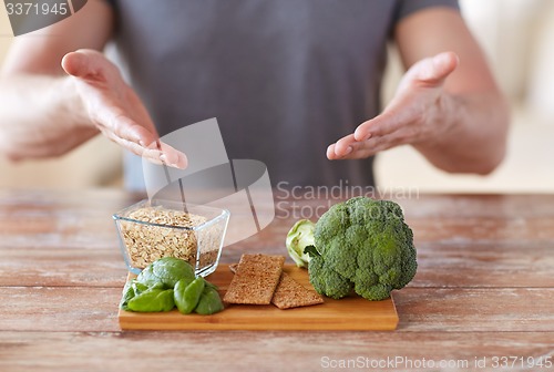 Image of close up of male hands showing food rich in fiber