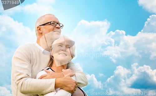 Image of happy senior couple over blue sky and clouds