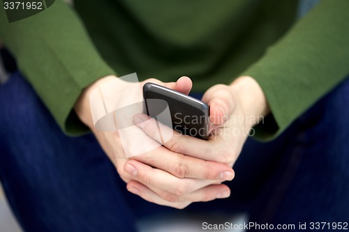 Image of close up of male hands with smartphone