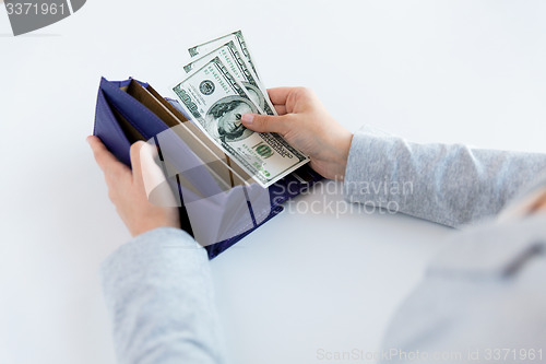 Image of close up of woman hands with wallet and money