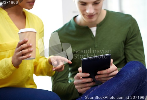 Image of close up of students with tablet pc and coffee