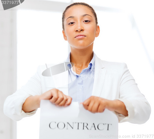 Image of african businesswoman tearing contract