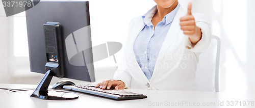 Image of african businesswoman with computer in office