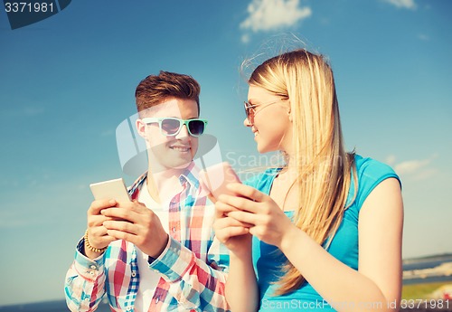 Image of smiling couple having fun outdoors
