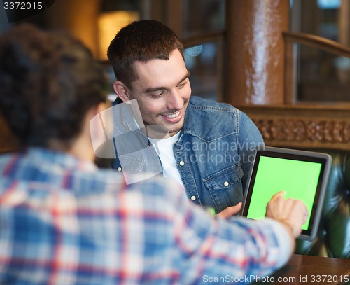 Image of male friends with tablet pc at bar