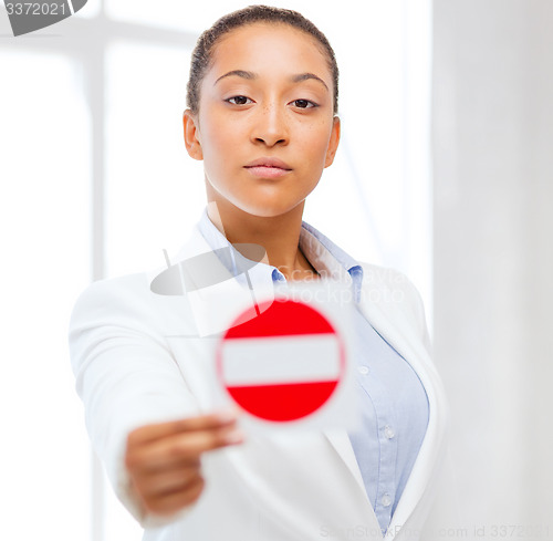 Image of african woman showing stop sign