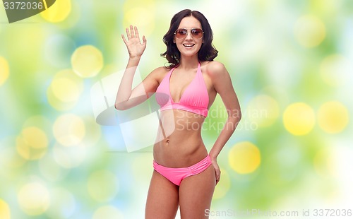 Image of happy woman in sunglasses and bikini swimsuit