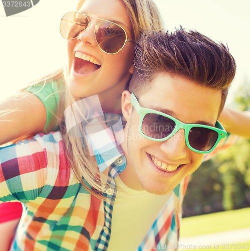 Image of smiling couple having fun in park