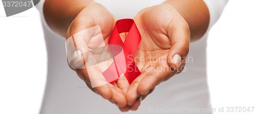 Image of hands holding red AIDS awareness ribbon