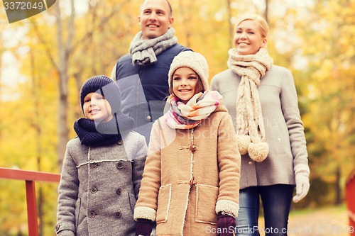 Image of happy family in autumn park