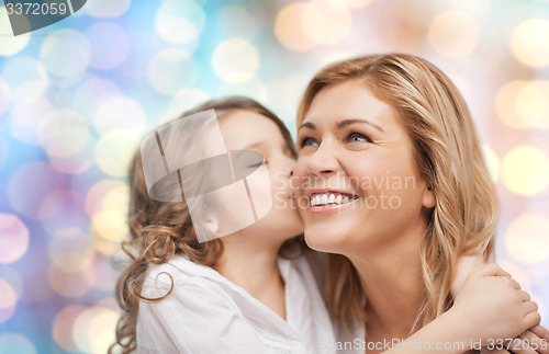 Image of happy mother with daughter hugging and kissing