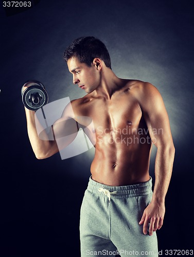 Image of young man with dumbbell