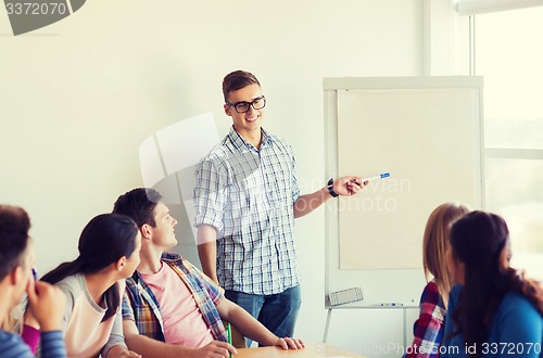 Image of group of smiling students with white board