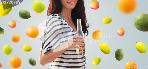 Image of close up of smiling young woman drinking on beach