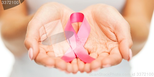 Image of hands holding pink breast cancer awareness ribbon