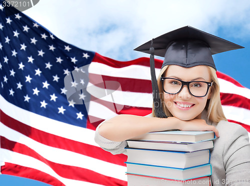 Image of happy student girl with books over american flag