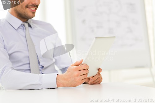 Image of close up of businessman hands with tablet pc