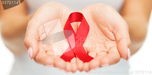 Image of hands holding red AIDS awareness ribbon