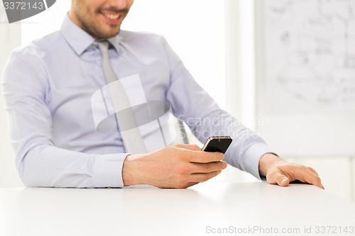 Image of close up of businessman with smartphone texting