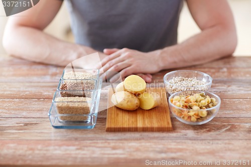 Image of close up of male hands with carbohydrate food